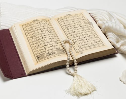 close-up-open-holy-book-with-bracelet